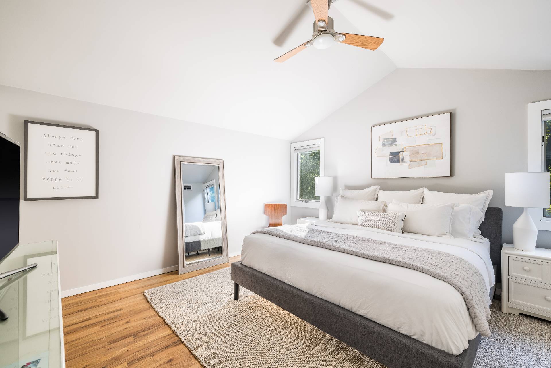 4594 Noyack Road Sag Harbor, NY 11963 - Photo 16 of 31 a bedroom with a bed and a painting on the wall