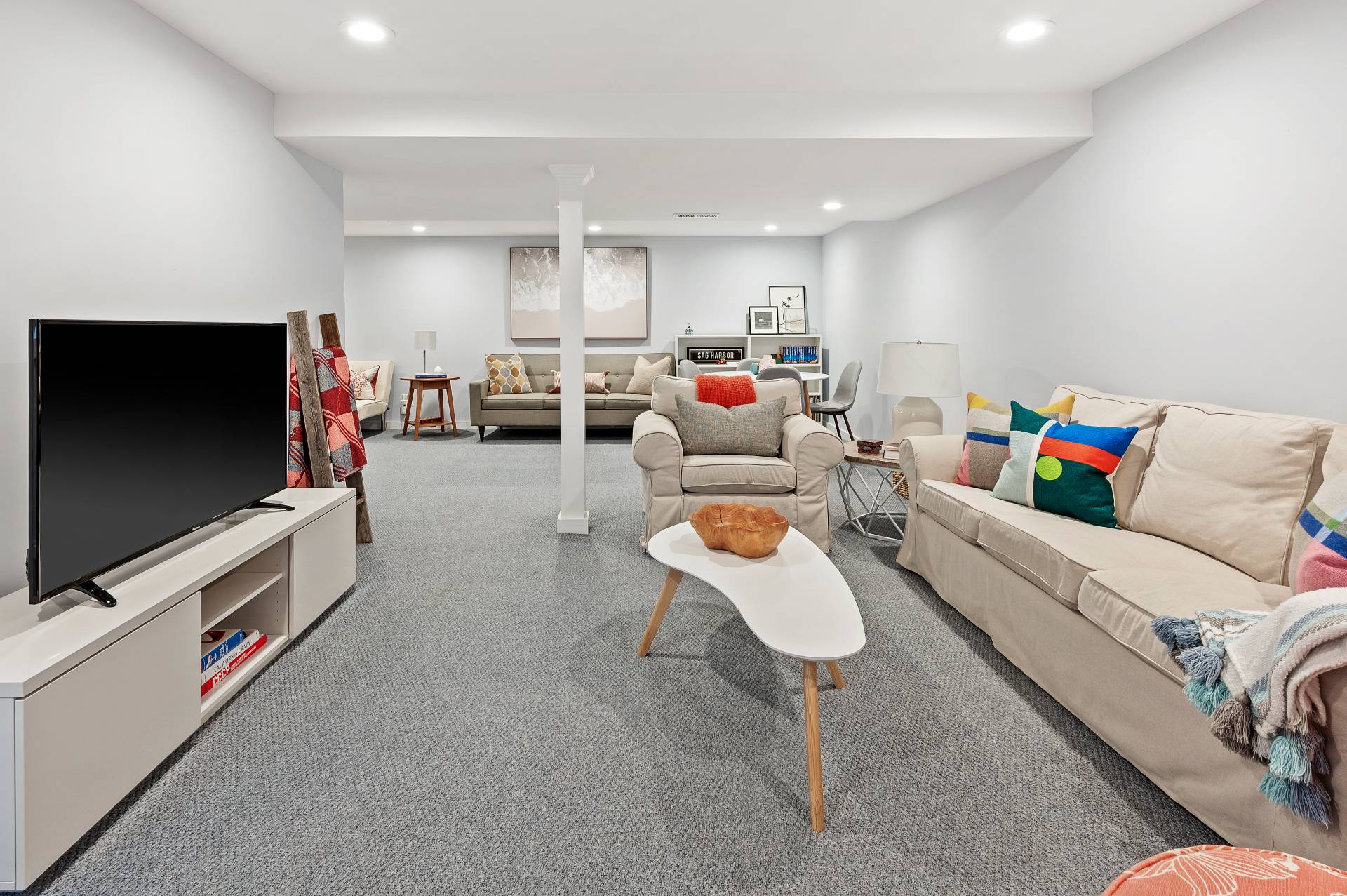 4594 Noyack Road Sag Harbor, NY 11963 - Photo 22 of 31 a living room with furniture and a flat screen tv