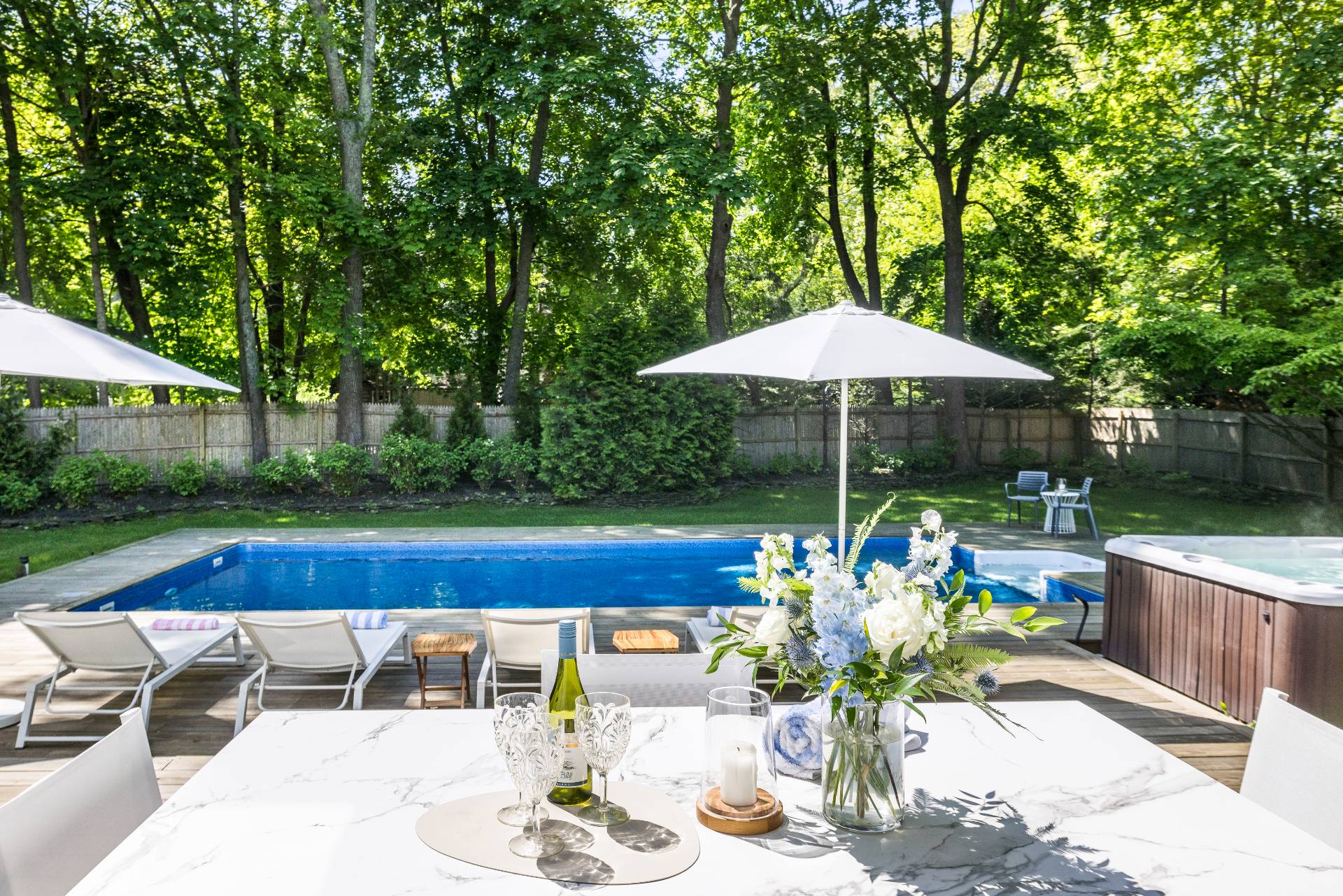 4594 Noyack Road Sag Harbor, NY 11963 - Photo 29 of 31 a view of a tables and chairs under an umbrella