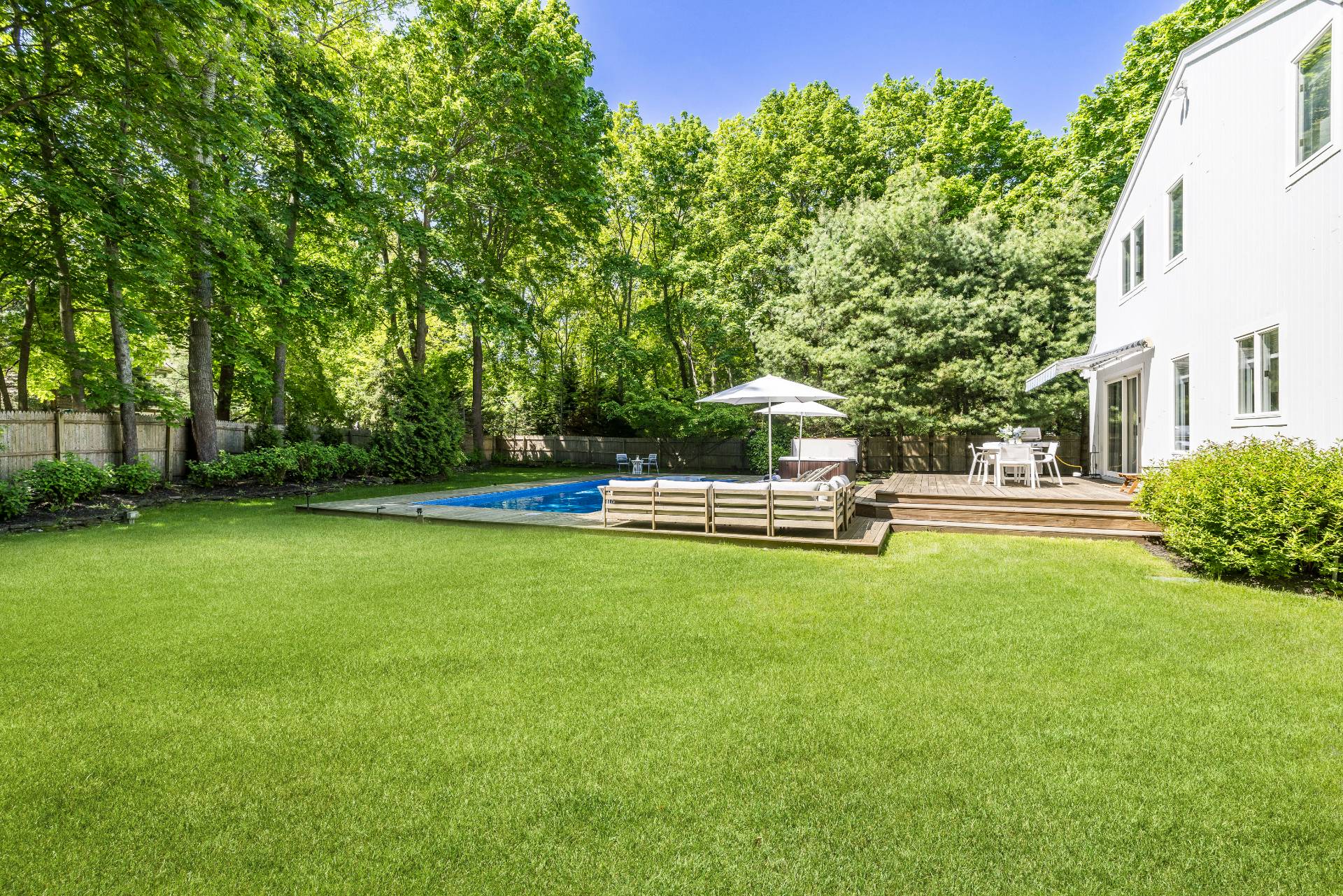 4594 Noyack Road Sag Harbor, NY 11963 - Photo 30 of 31 a swimming pool with wooden fence