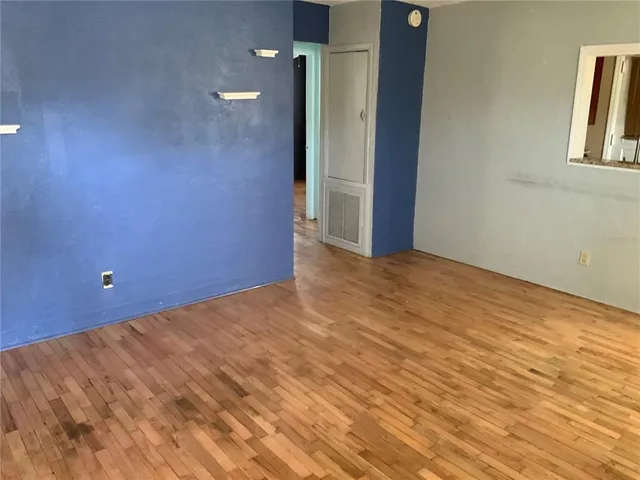 a view of a room with wooden floor