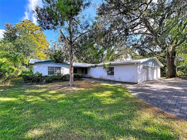 a kitchen with stainless steel appliances granite countertop a sink a stove and refrigerator