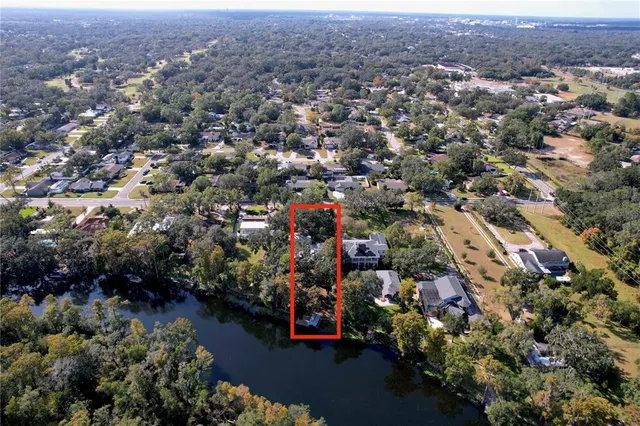 a kitchen with stainless steel appliances granite countertop a refrigerator a stove and a sink with wooden floors