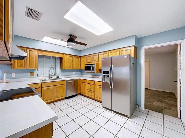 an empty room with a ceiling fan and a window