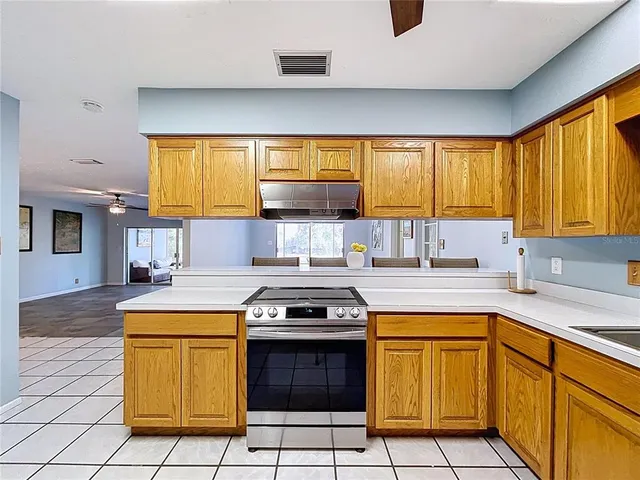 a spacious bathroom with a granite countertop toilet sink and mirror