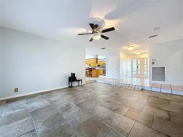 a living room with furniture and a floor to ceiling window
