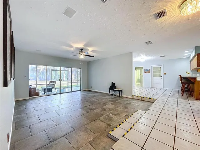 a living room with furniture a table and chairs