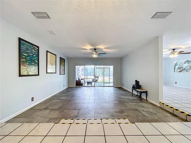 a view of a patio with a table chairs and a yard