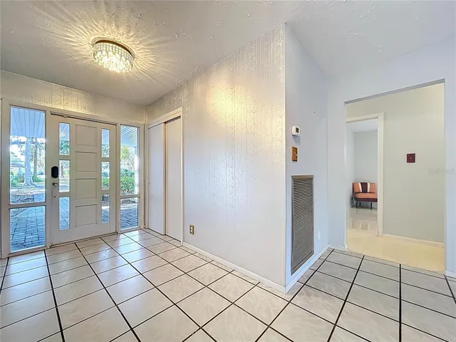 a view of a swimming pool with lawn chairs under an umbrella