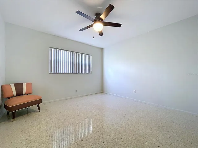 a wooden pier with boats and trees in the background