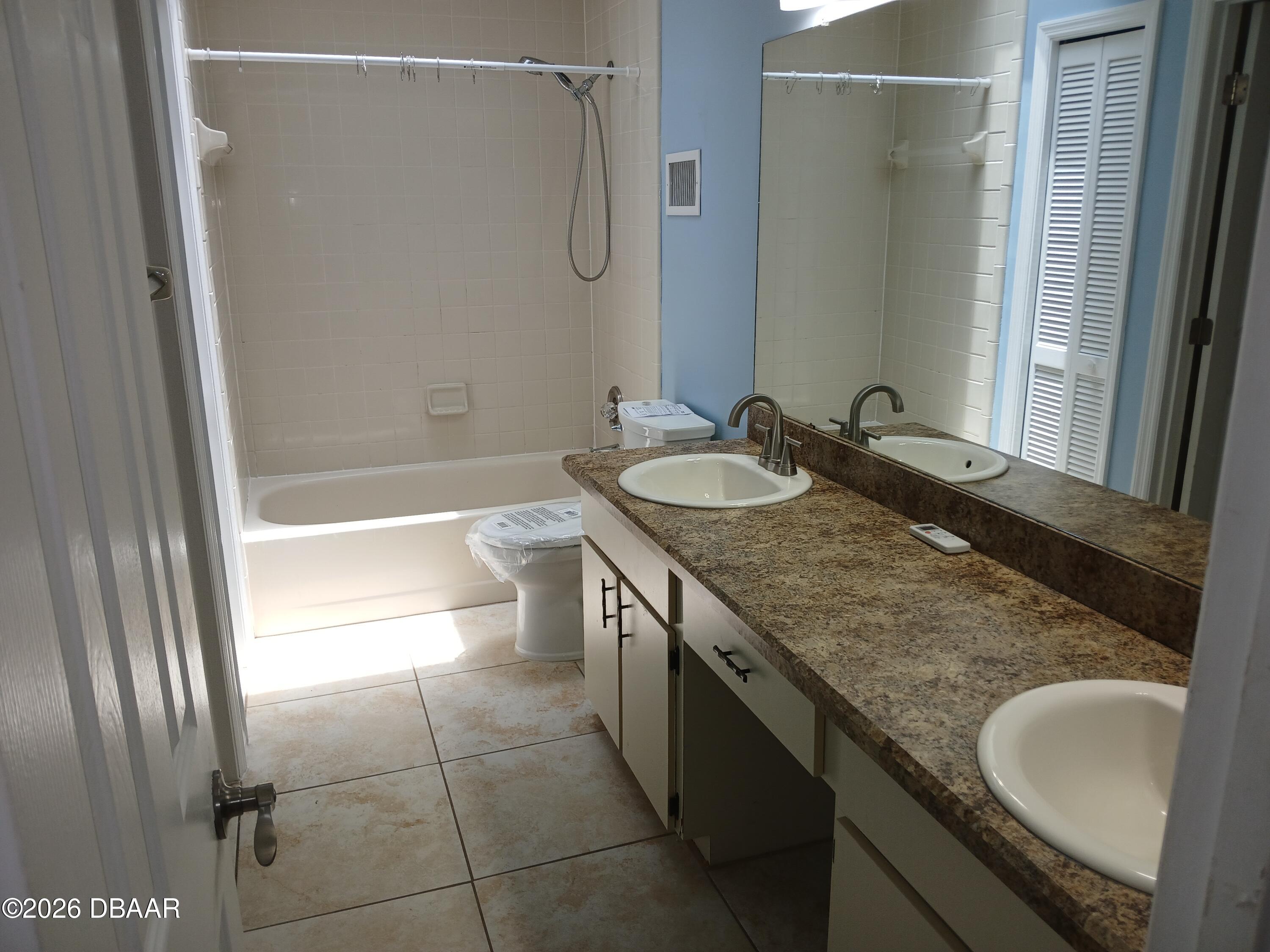 4514 Alder Drive Port Orange, FL 32127 - Photo 12 of 15 a bathroom with a granite countertop sink a toilet and shower