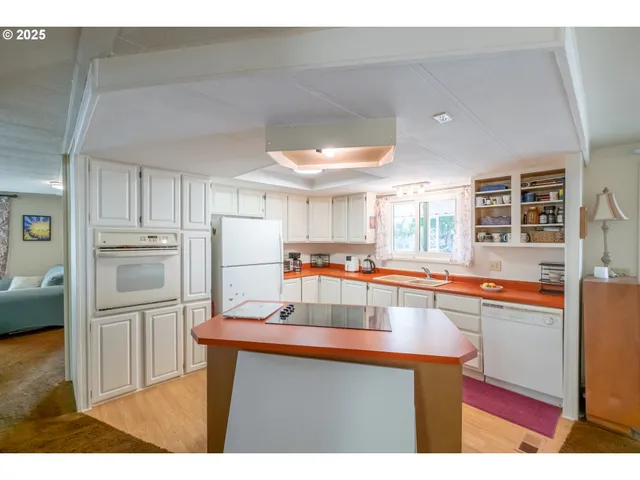 a kitchen with refrigerator and cabinets