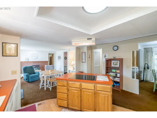 a kitchen with stainless steel appliances kitchen island granite countertop a sink and cabinets