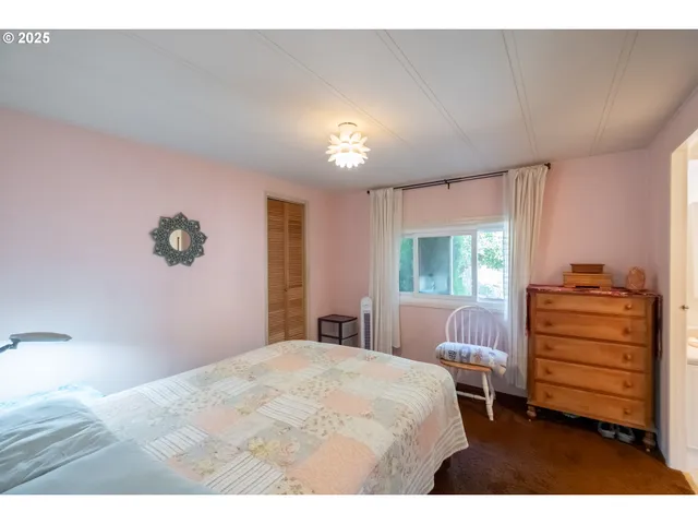 a bedroom with furniture and a window