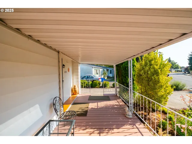 a view of a patio with table and chairs with wooden floor and fence