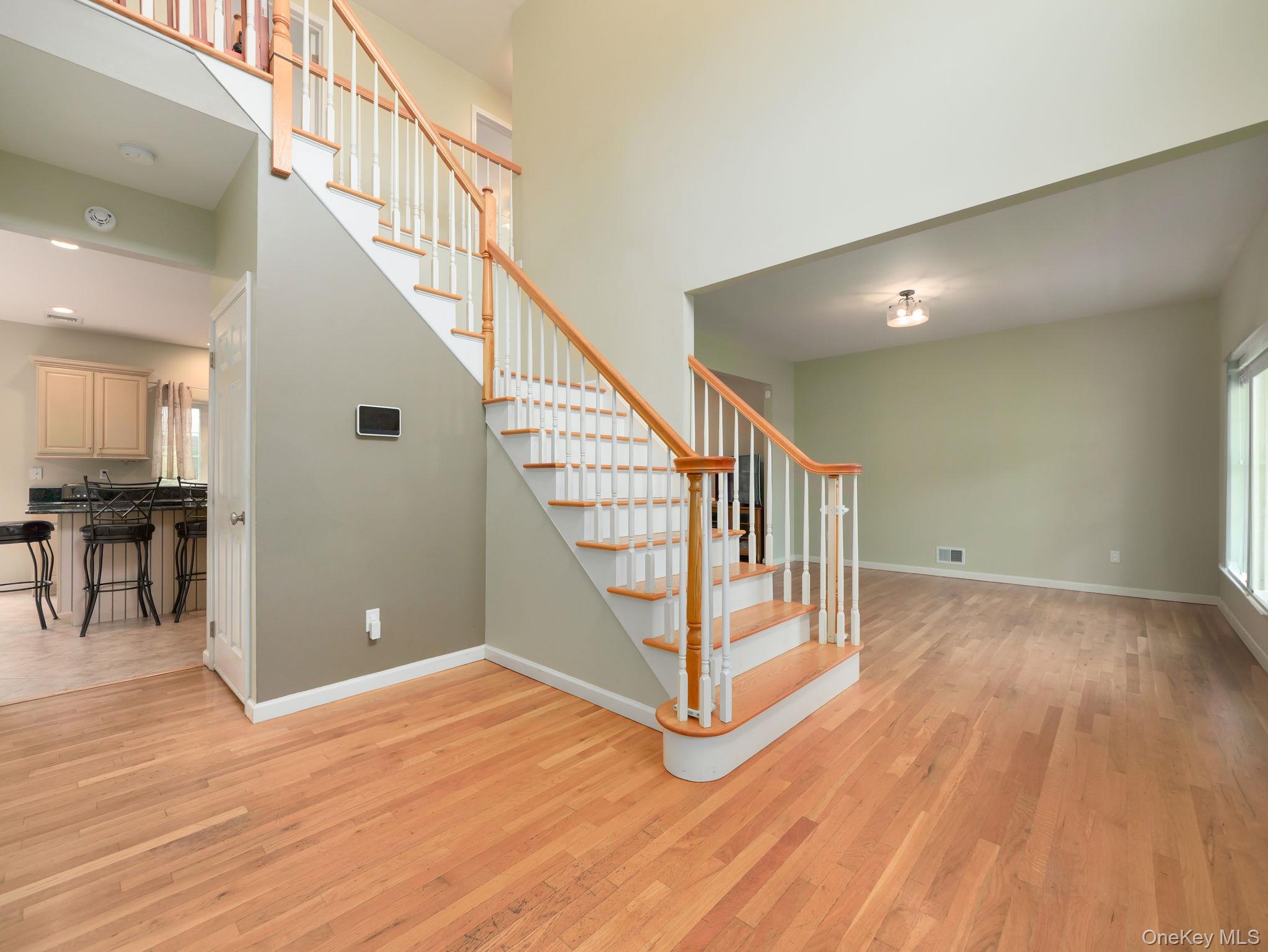 74 Red Maple Way New Windsor, NY 12553 - Photo 11 of 25 Stairs featuring wood finished floors and a towering ceiling