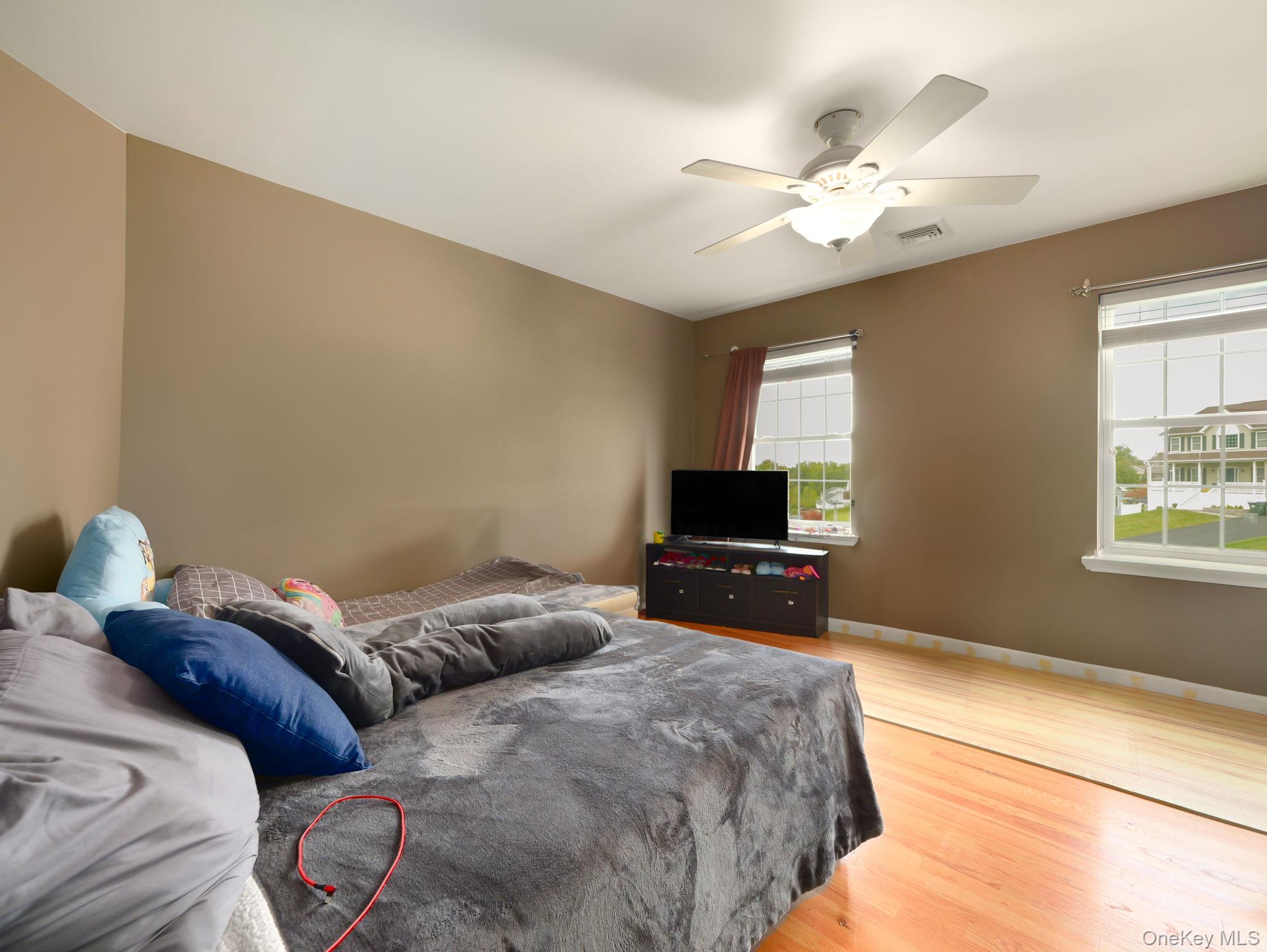 74 Red Maple Way New Windsor, NY 12553 - Photo 15 of 25 Bedroom with light wood-style flooring and a ceiling fan