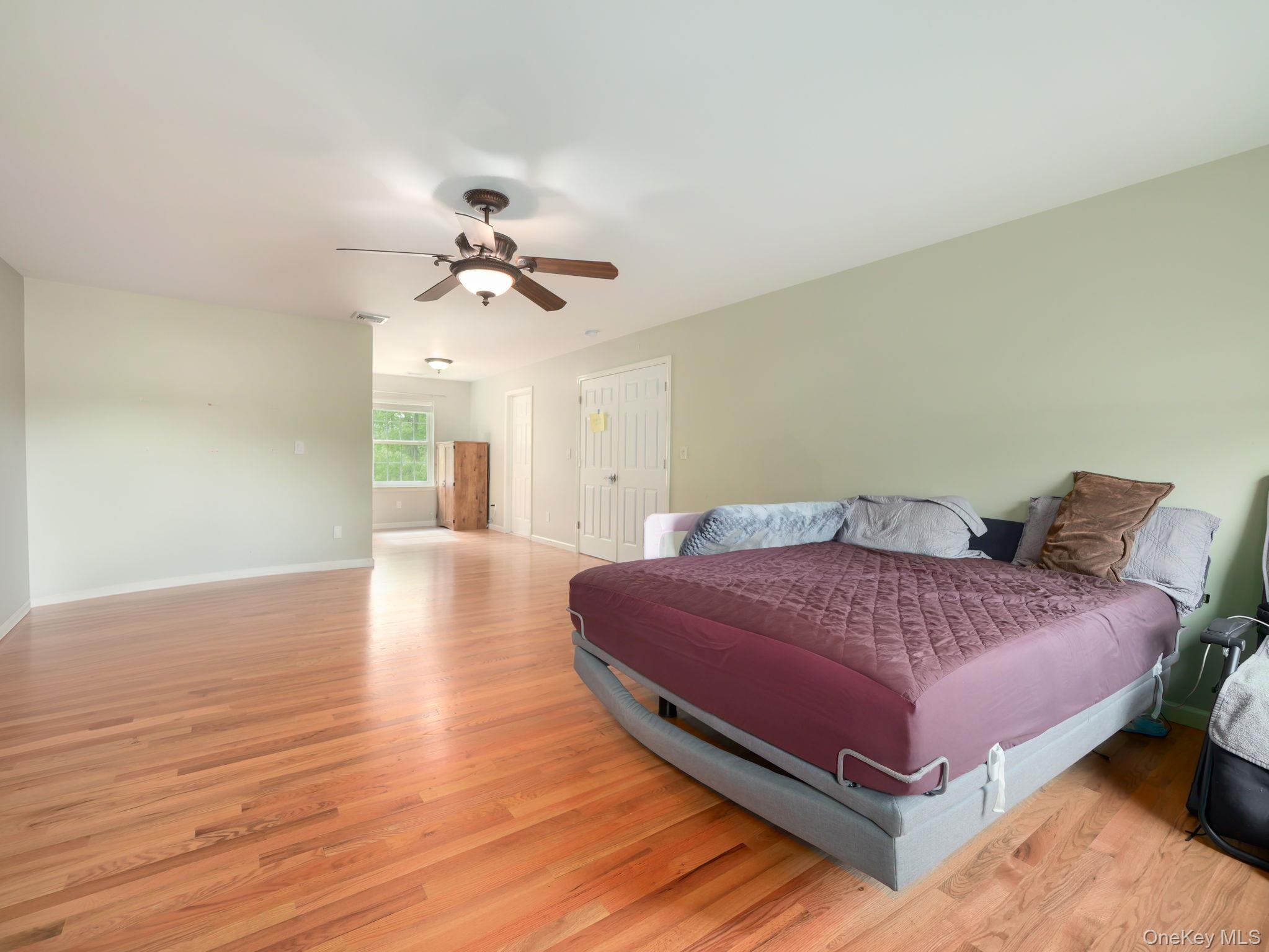 74 Red Maple Way New Windsor, NY 12553 - Photo 16 of 25 Bedroom with light wood-style floors, ceiling fan, and a closet