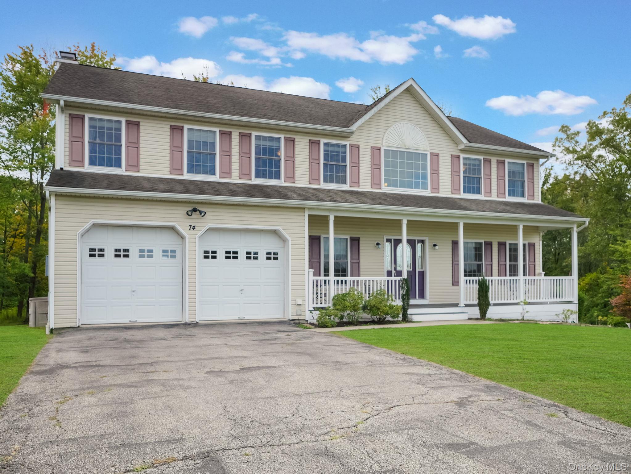 74 Red Maple Way New Windsor, NY 12553 - Photo 2 of 25 Colonial-style house with driveway, a porch, a garage, a front yard, and a chimney