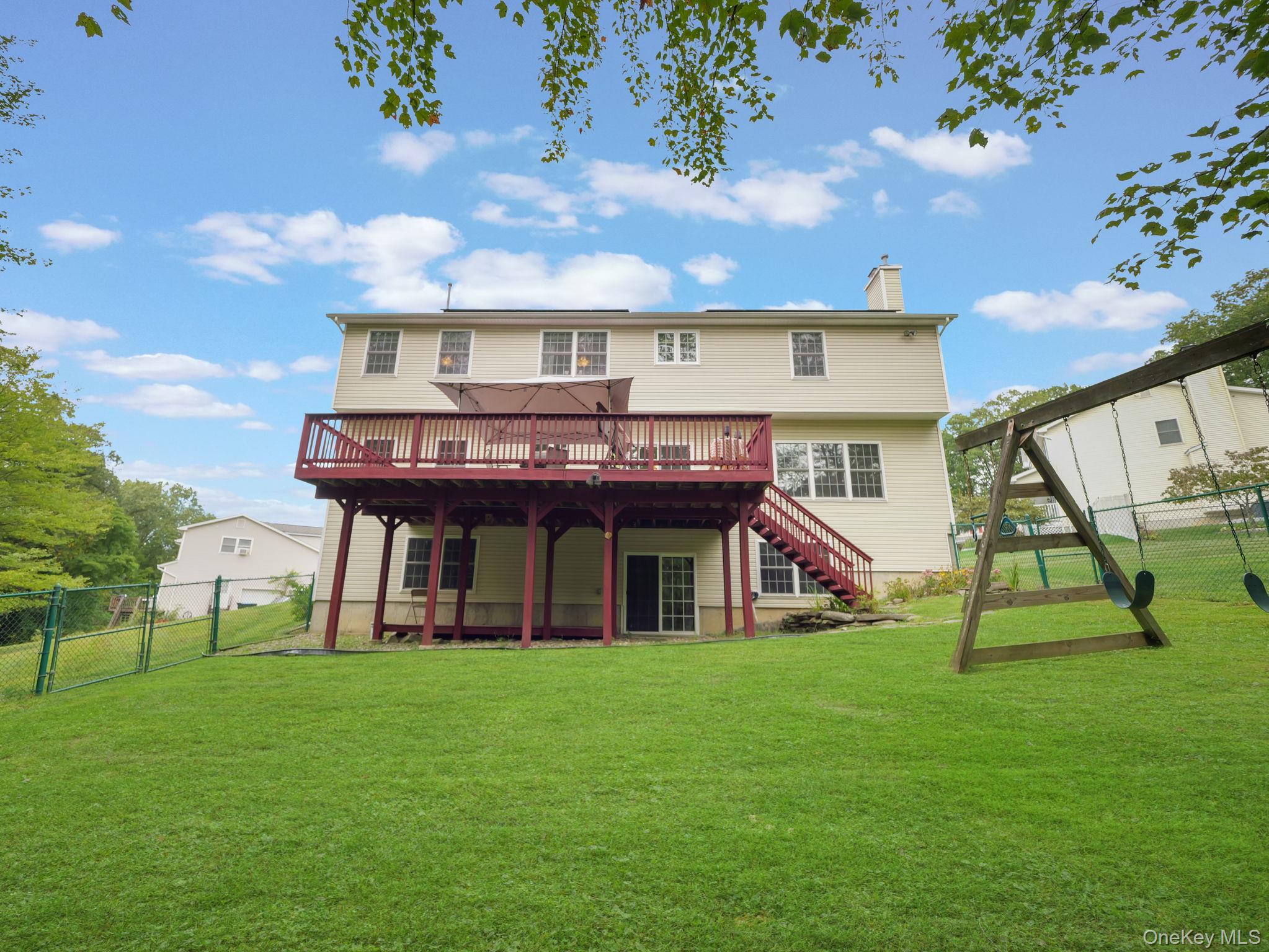 74 Red Maple Way New Windsor, NY 12553 - Photo 23 of 25 Back of property with a deck, a chimney, a gate, and stairway