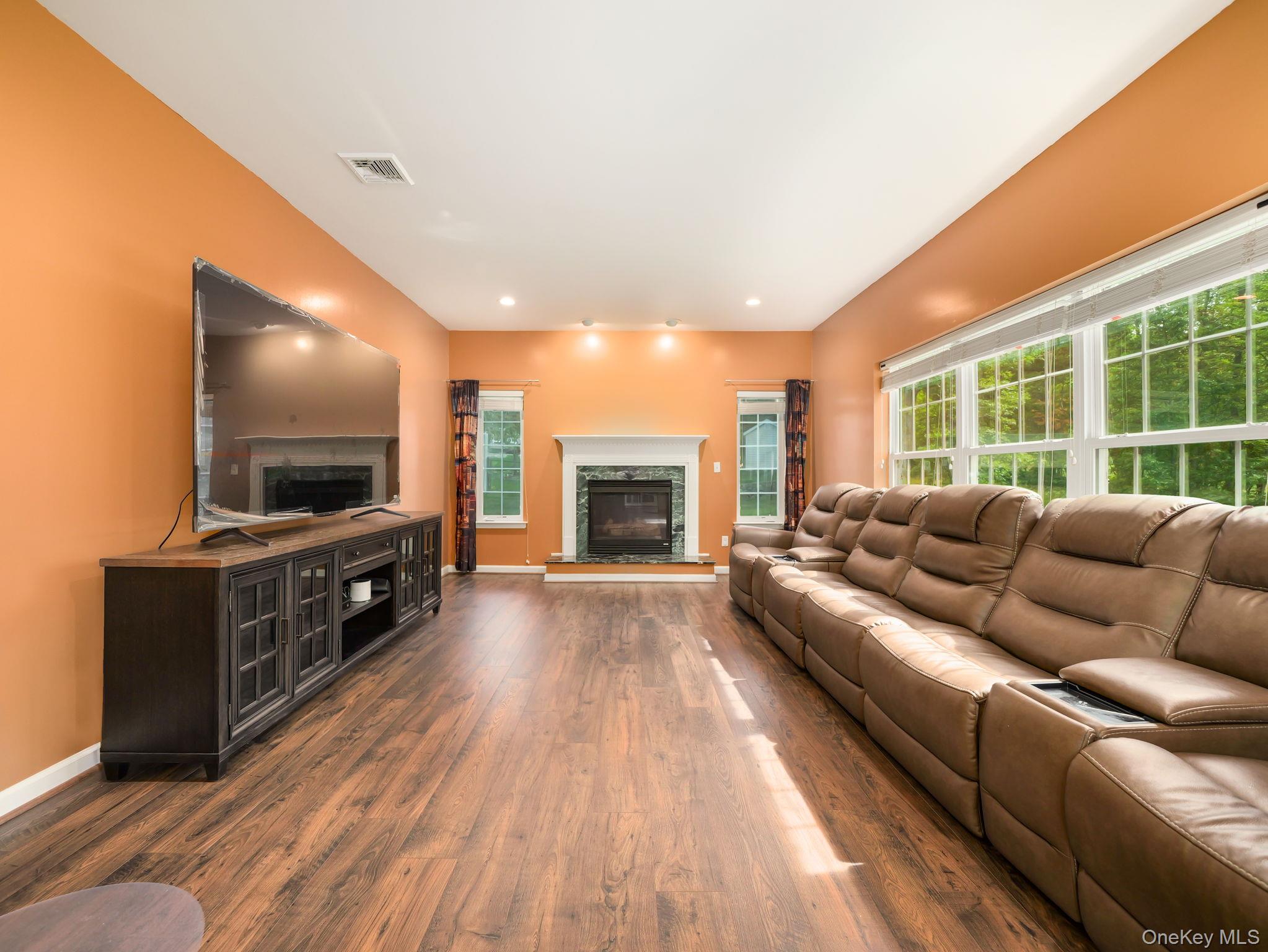 74 Red Maple Way New Windsor, NY 12553 - Photo 3 of 25 Living area featuring dark wood finished floors, a high end fireplace, and recessed lighting