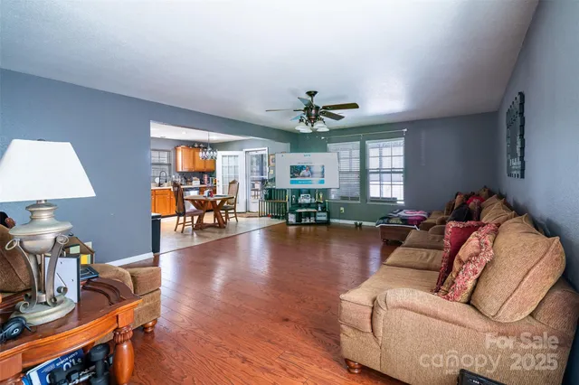 a kitchen with stainless steel appliances kitchen island granite countertop a stove top oven a sink a dining table and chairs