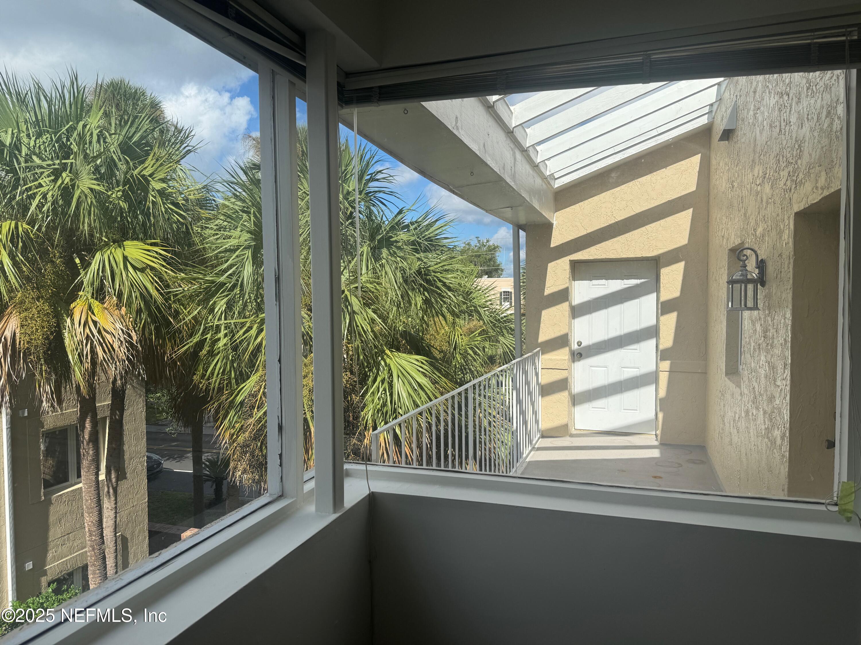 2912 St Johns Avenue, Unit 17 Jacksonville, FL 32205 - Photo 13 of 60 a view of a glass door with a tree