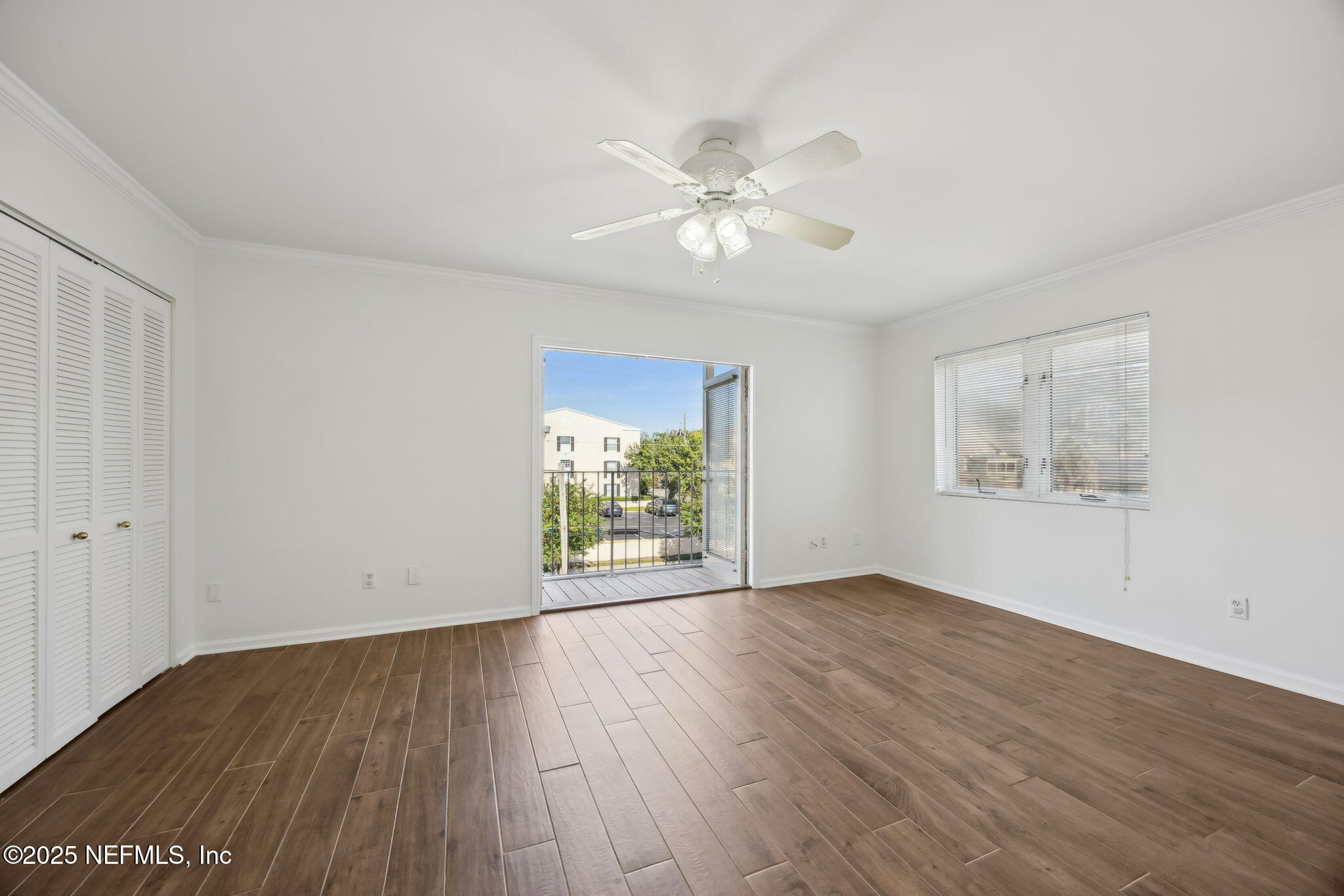 2912 St Johns Avenue, Unit 17 Jacksonville, FL 32205 - Photo 36 of 60 a view of an empty room with wooden floor and a window