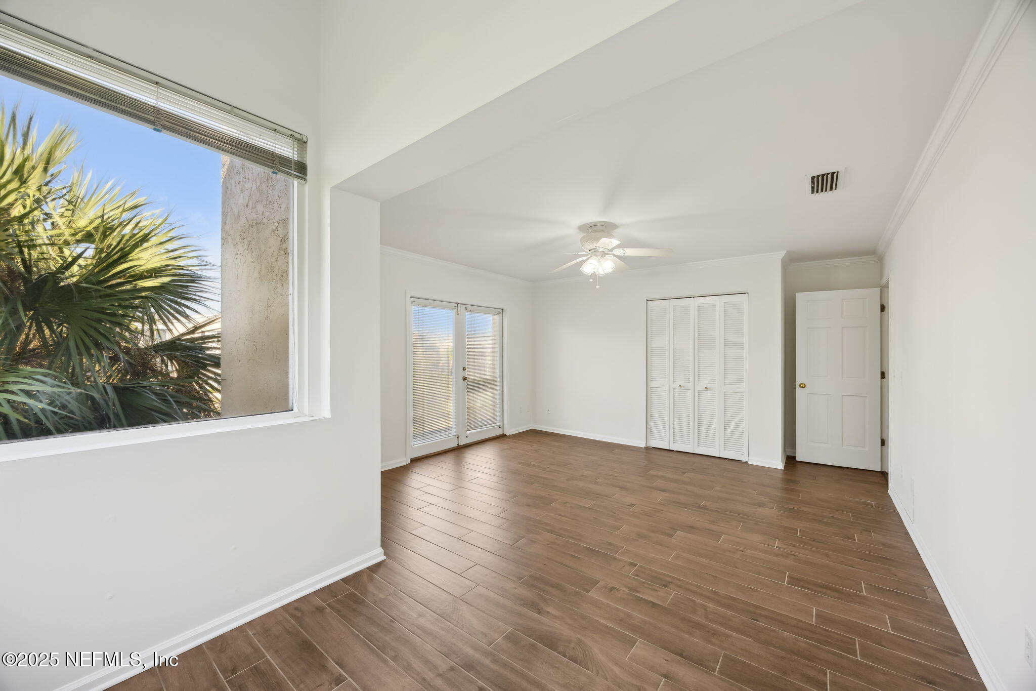 2912 St Johns Avenue, Unit 17 Jacksonville, FL 32205 - Photo 40 of 60 a view of an empty room with a window and wooden floor
