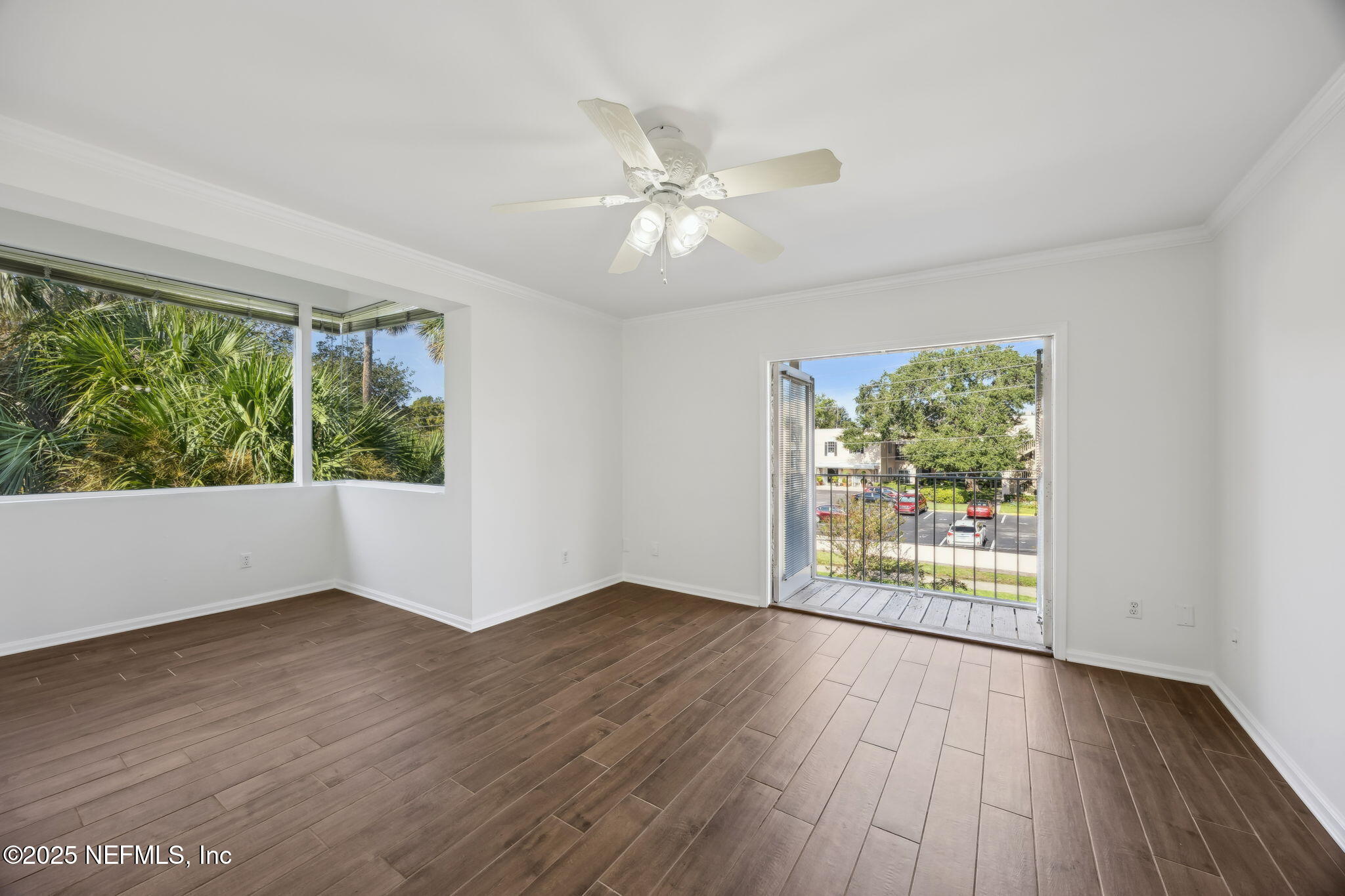 2912 St Johns Avenue, Unit 17 Jacksonville, FL 32205 - Photo 43 of 60 a view of an empty room with wooden floor and a window