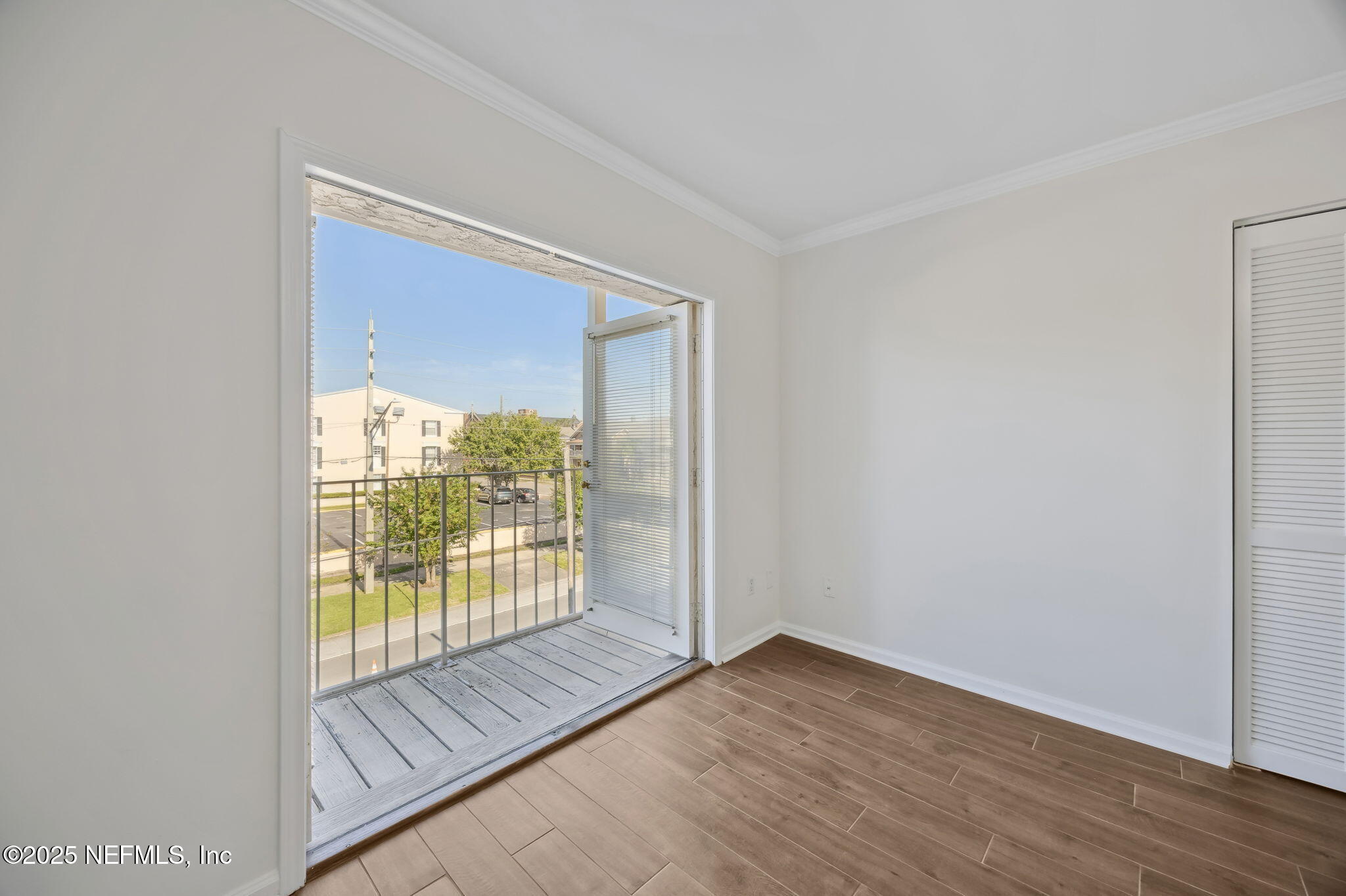 2912 St Johns Avenue, Unit 17 Jacksonville, FL 32205 - Photo 45 of 60 a view of an empty room with wooden floor and a window