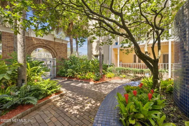 a view of a glass door with a tree