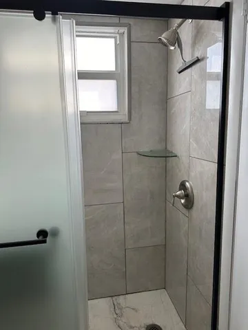 a bathroom with a glass door shower