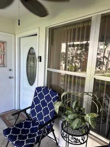 a front view of a house with fountain potted plants