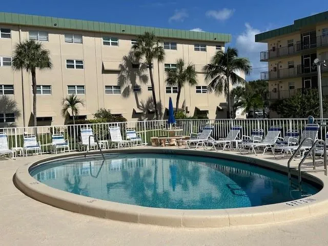 a view of a swimming pool with outdoor seating