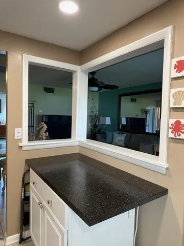 a view of a refrigerator in kitchen and a sink