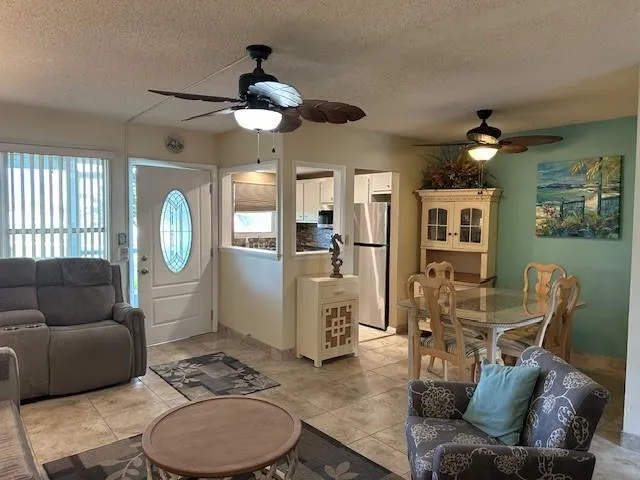 a living room with furniture a fireplace and a chandelier