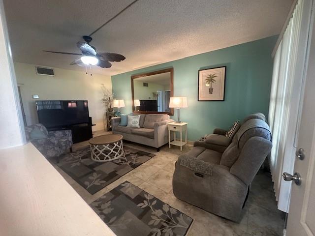 808 Southeast 7th Street, Unit 101B Deerfield Beach, FL 33441 - Photo 33 of 36 a living room with furniture a flat screen tv and a table