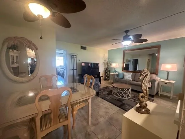 a living room with furniture and a large mirror