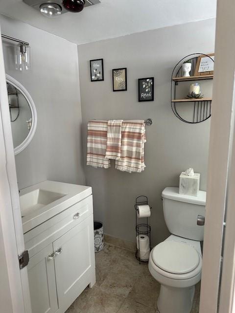 808 Southeast 7th Street, Unit 101B Deerfield Beach, FL 33441 - Photo 10 of 36 a bathroom with a toilet a sink and a mirror