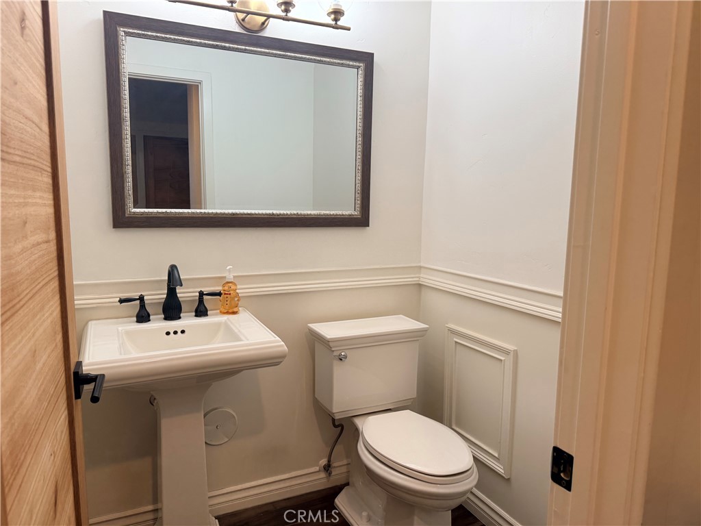 3713 Calle Curacso Riverside, CA 92503 - Photo 15 of 17 a bathroom with a toilet sink and mirror