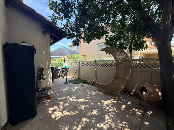a view of a chairs and table in backyard