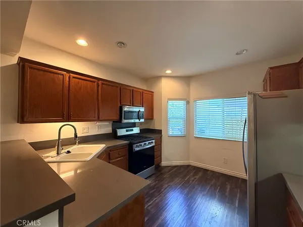 a kitchen with wooden floors and wooden cabinets