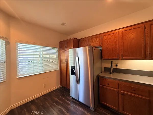 a kitchen with stainless steel appliances granite countertop a refrigerator and a sink
