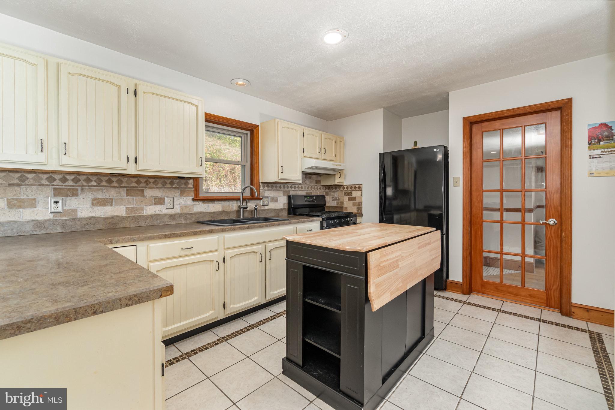 798 Byerland Church Road Willow Street, PA 17584 - Photo 13 of 31 a kitchen with stainless steel appliances granite countertop a stove a refrigerator and a sink