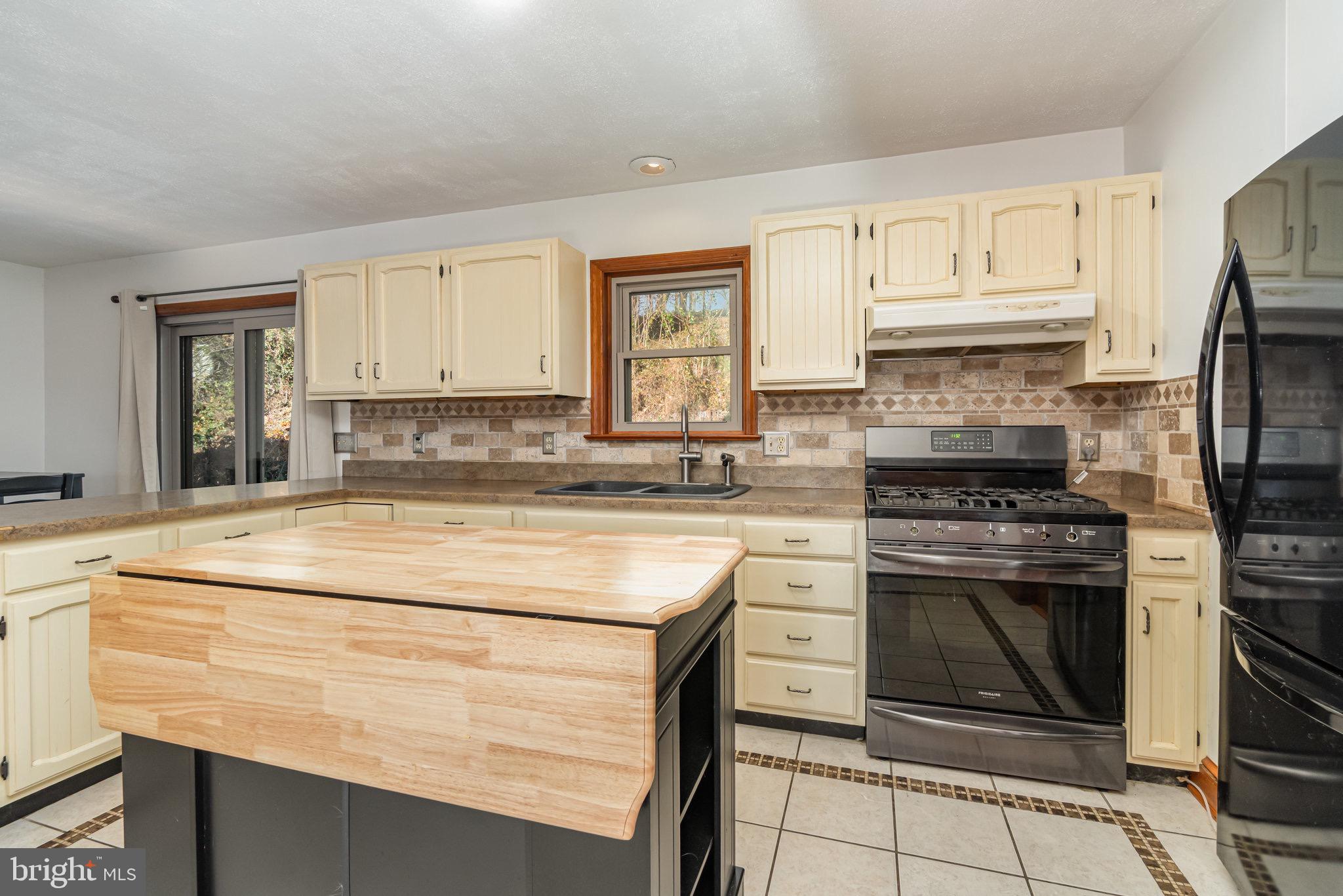 798 Byerland Church Road Willow Street, PA 17584 - Photo 14 of 31 a kitchen with granite countertop a stove sink and refrigerator