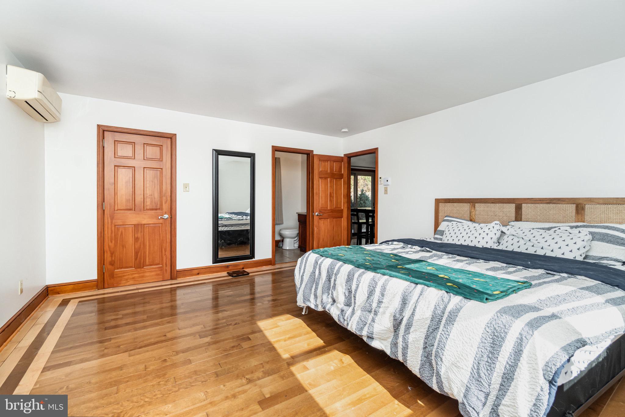 798 Byerland Church Road Willow Street, PA 17584 - Photo 21 of 31 a bedroom with a bed and dresser with floor to ceiling window