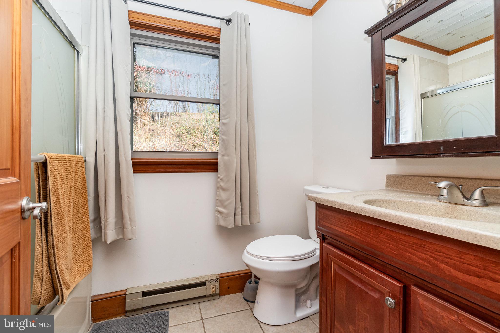 798 Byerland Church Road Willow Street, PA 17584 - Photo 26 of 31 a bathroom with a toilet a sink and a window