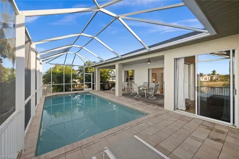 a view of a patio with table and chairs under an umbrella