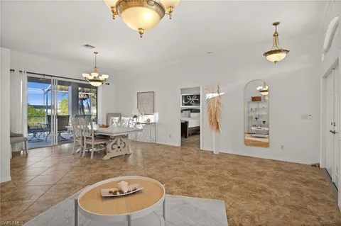 a living room with couches chairs and kitchen view